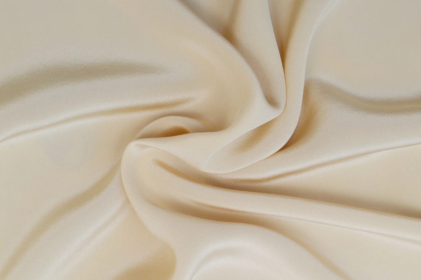 Beige textile arranged in folds.
