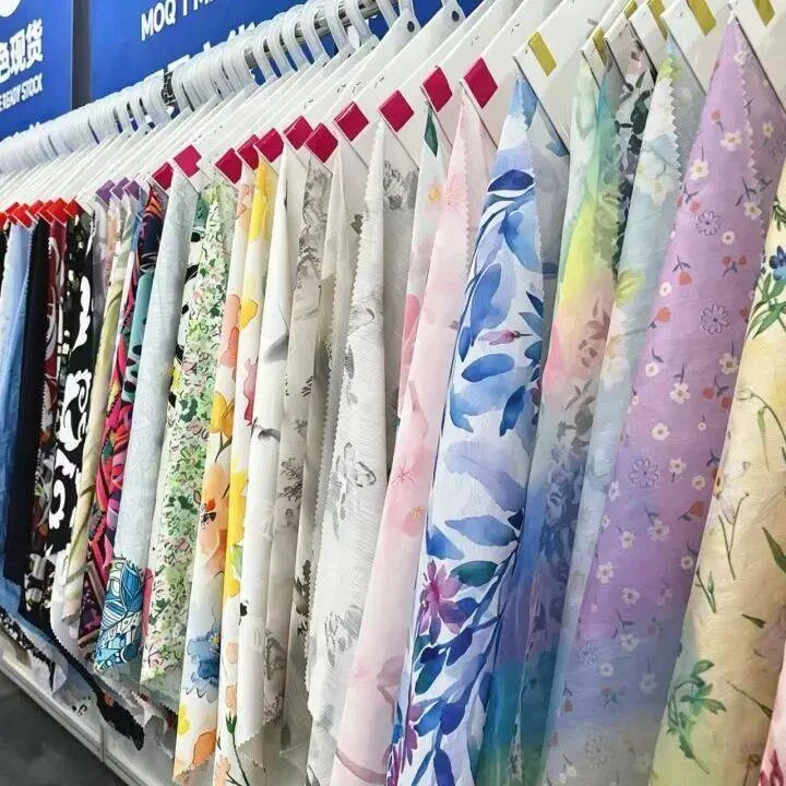 Printed fabric samples pictured in the October 2026 Shengze expo report.